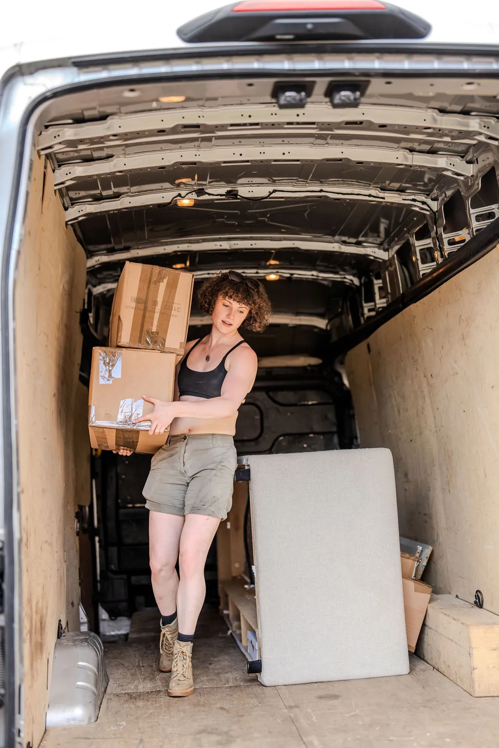 A Han With A Van mover loading packed boxes into the van, with the kit visible.